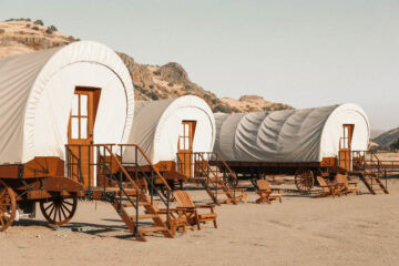 Three cozy covered wagons with stairs