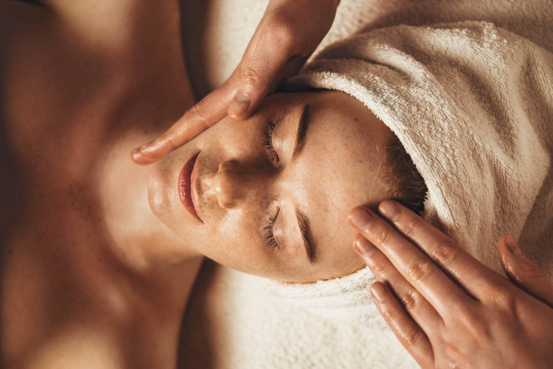 Woman receiving a relaxing facial massage