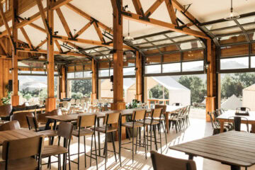 Spacious wooden dining area with outdoor view.