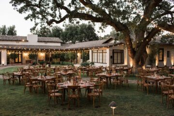 Outdoor event venue with tables and string lights