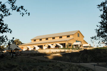 Barn event venue with outdoor seating.