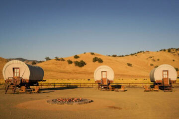 Covered wagons on ranch with fire pit