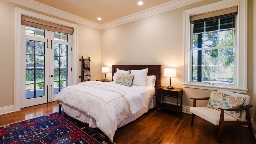 Cozy bedroom with large windows and natural light.