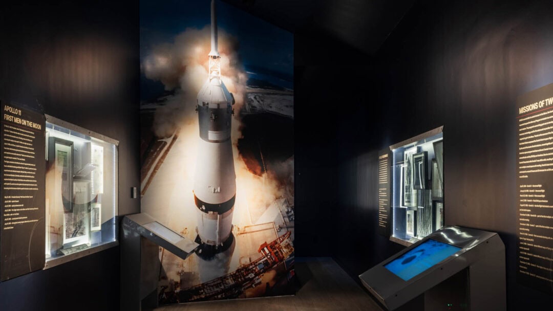 Apollo 11 rocket launch exhibit in museum.