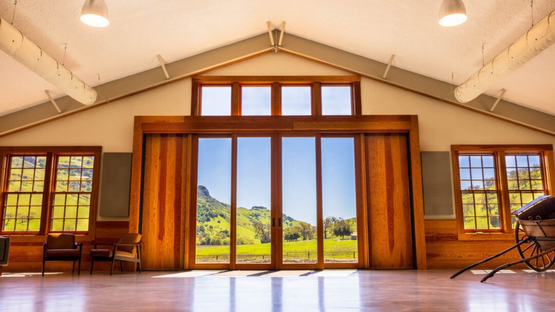 Large windows with scenic hill view.