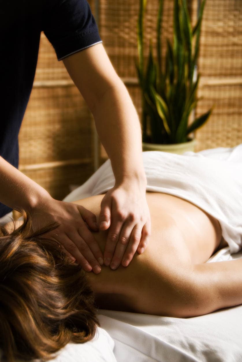 Person receiving a back massage at spa